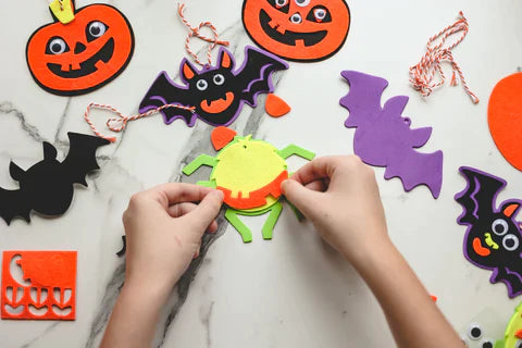 children making halloween decorations for halloween
