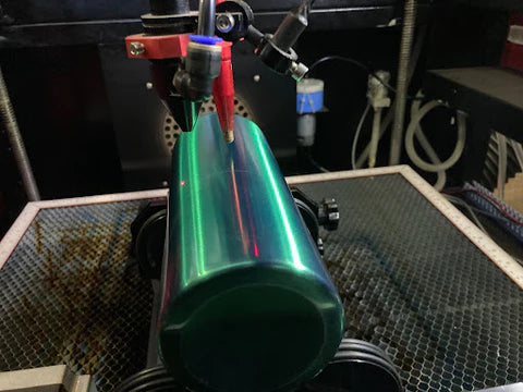 Move the laser head directly above the tumbler and raise your workbed to the proper focal distance.