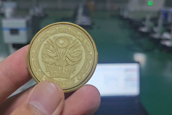 a hand holding up a laser engraved challenge coin