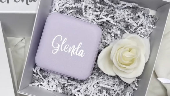 Personalised faux leather case in a gift box, featuring a laser foil engraved name “Glenda” alongside a white rose.