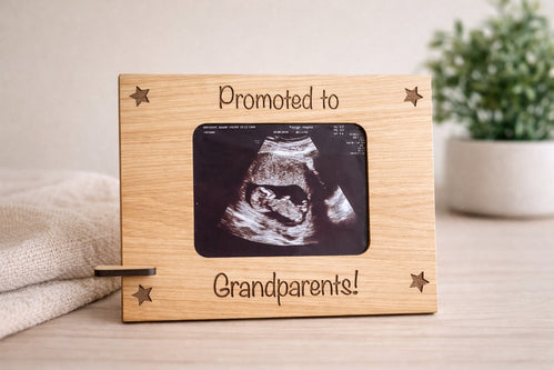 Wooden frame with ultrasound photo and 'Promoted to Grandparents!' text on a neutral background