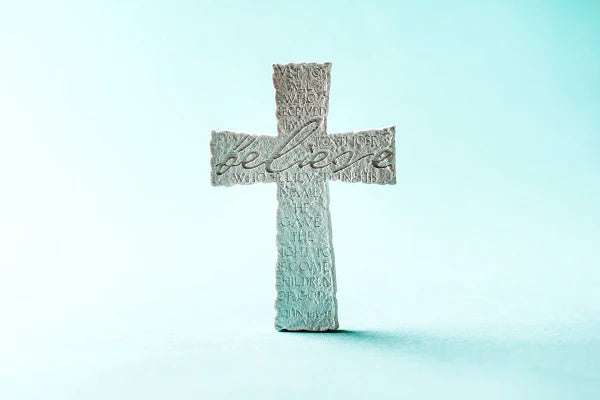 stone_cross_with_inscription_believe_on_blue_backg